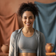 Portrait of a smiling woman in athletic wear, looking confident and happy.